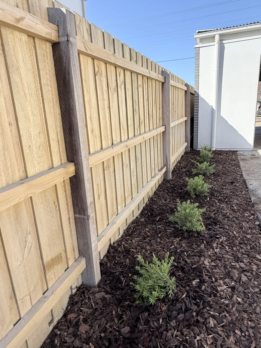 Timber fence with a planted garden bed