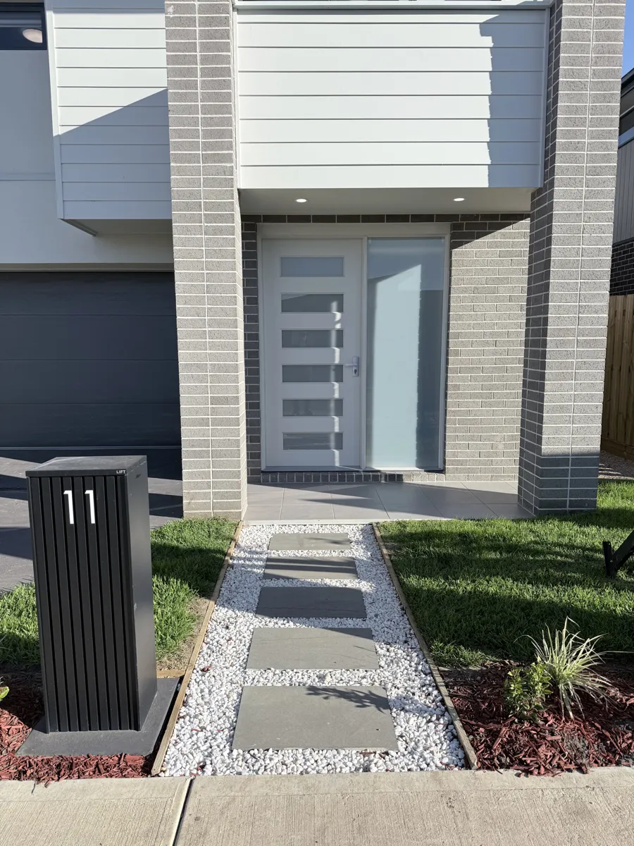 Entrance with paved path and planting
