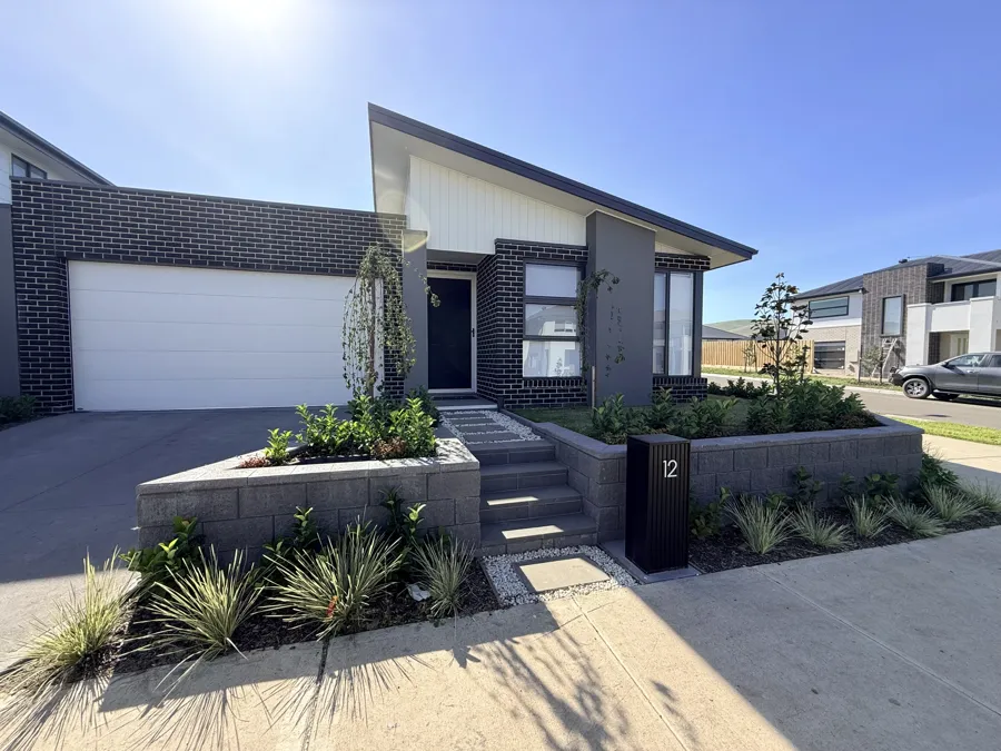 Block retaining walls either side of the front steps with new garden beds, built by Melbourne Fencing Solutions
