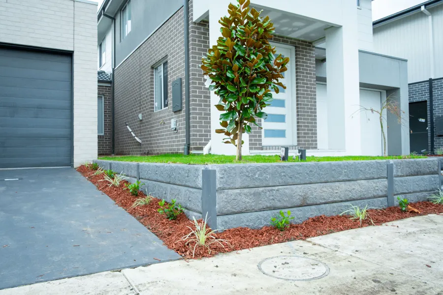Sleeper garden wall along the driveway